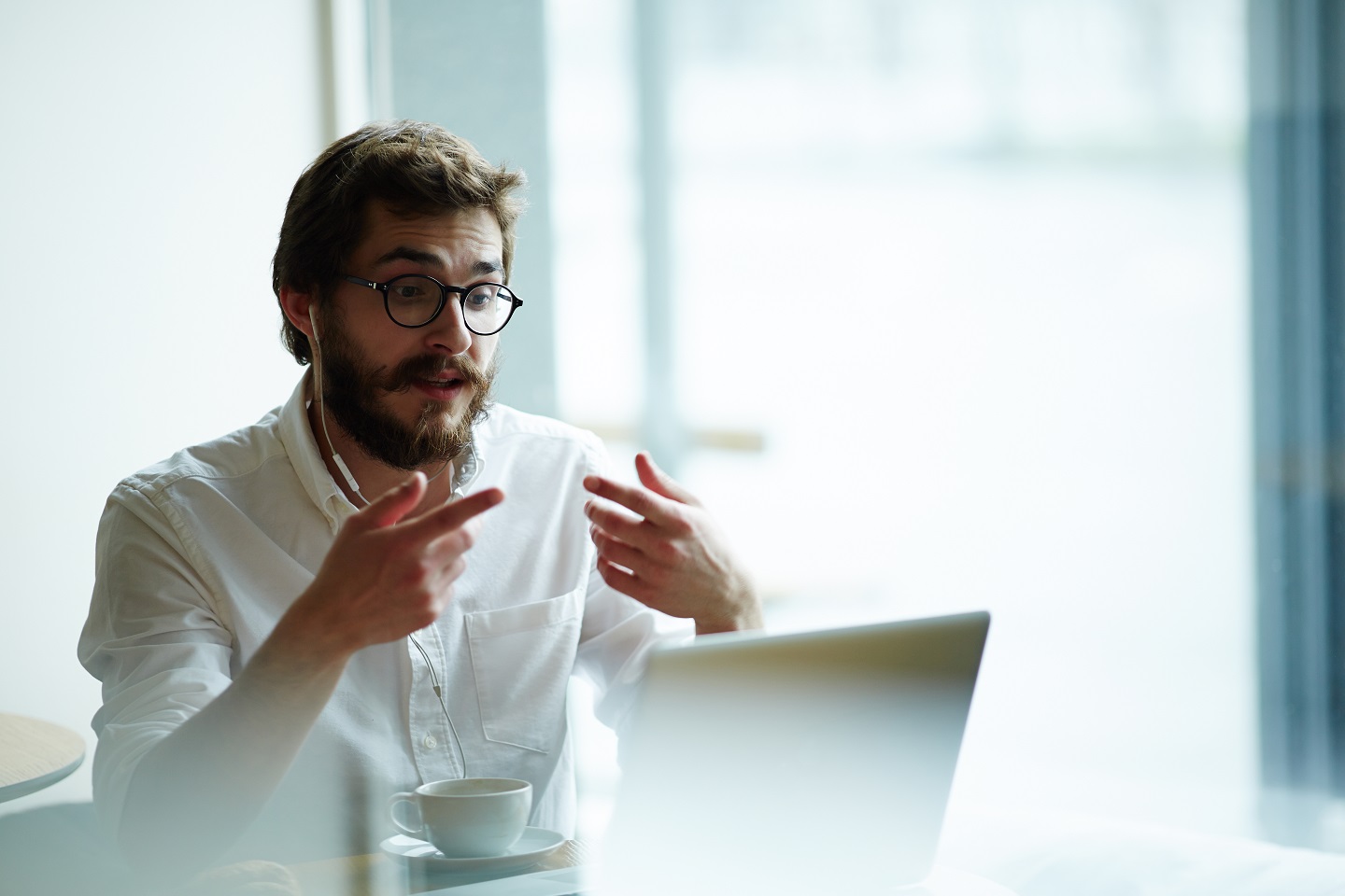 Young specialist communicating with employer through video-chat
